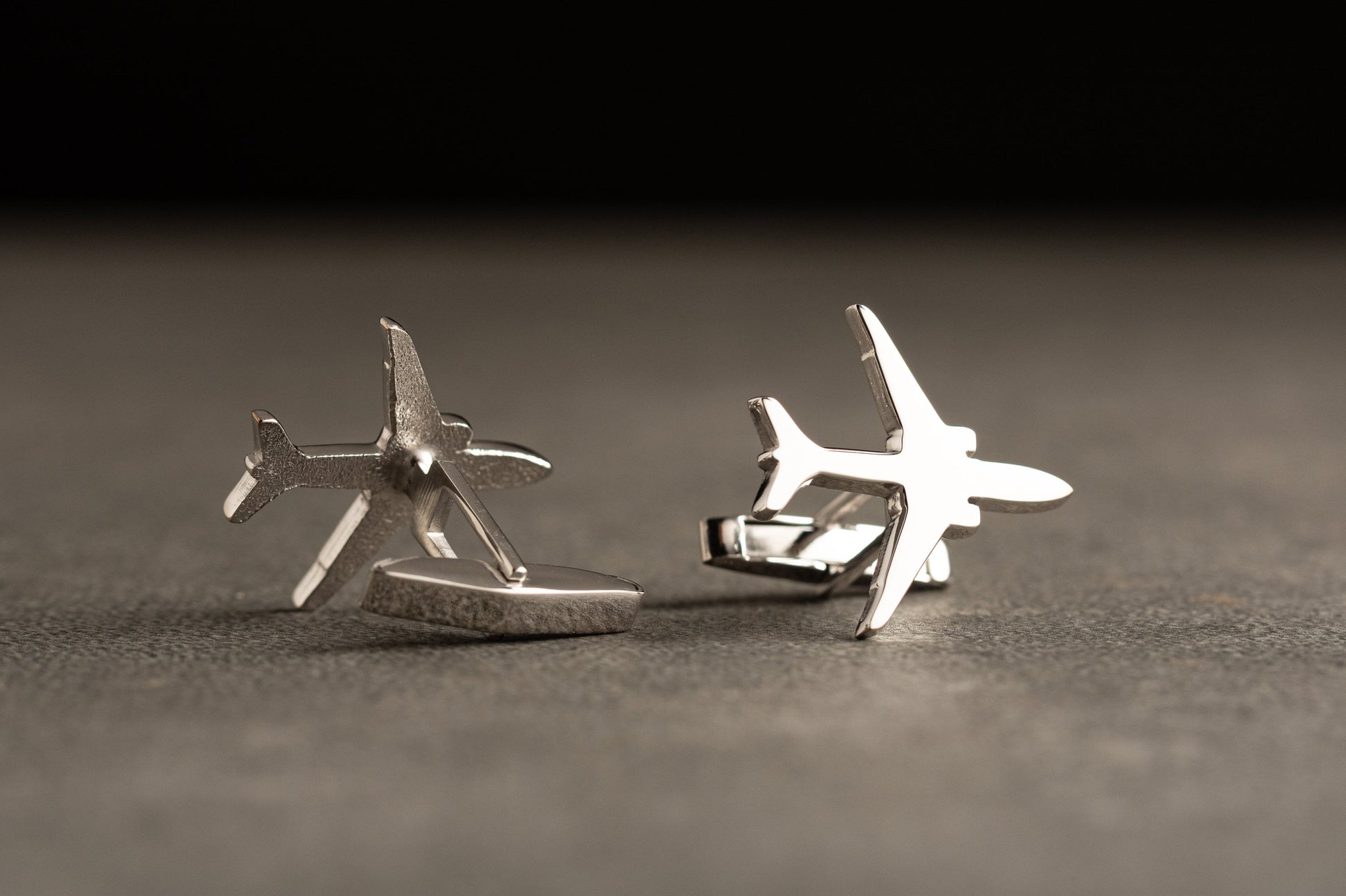 Close up detail of Boeing 777 airplane silhouette on personalized silver cufflinks