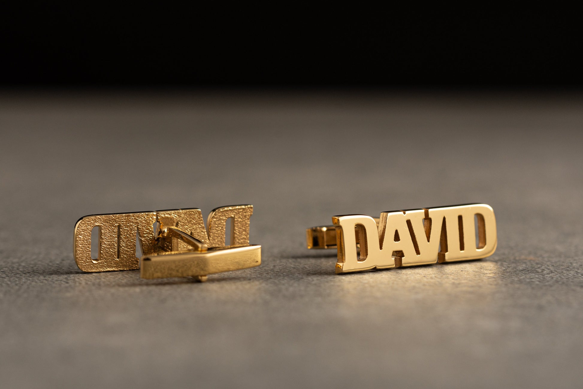 Close up of personalized 18k gold plated name cufflinks