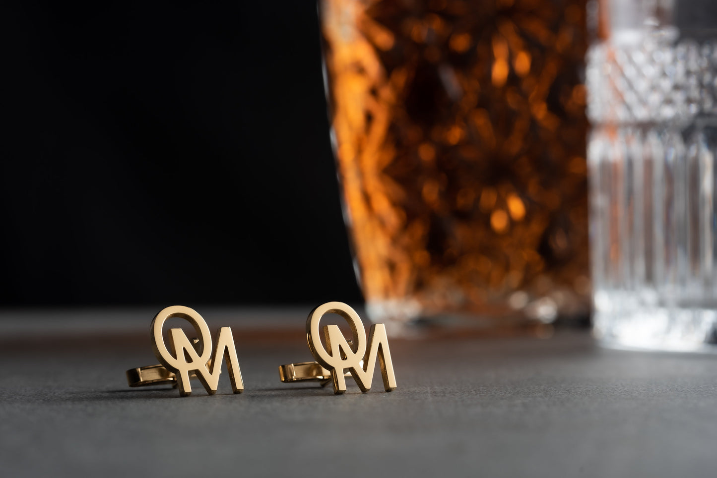 Detailed view of custom monogram cufflinks in gold and rhodium finishes