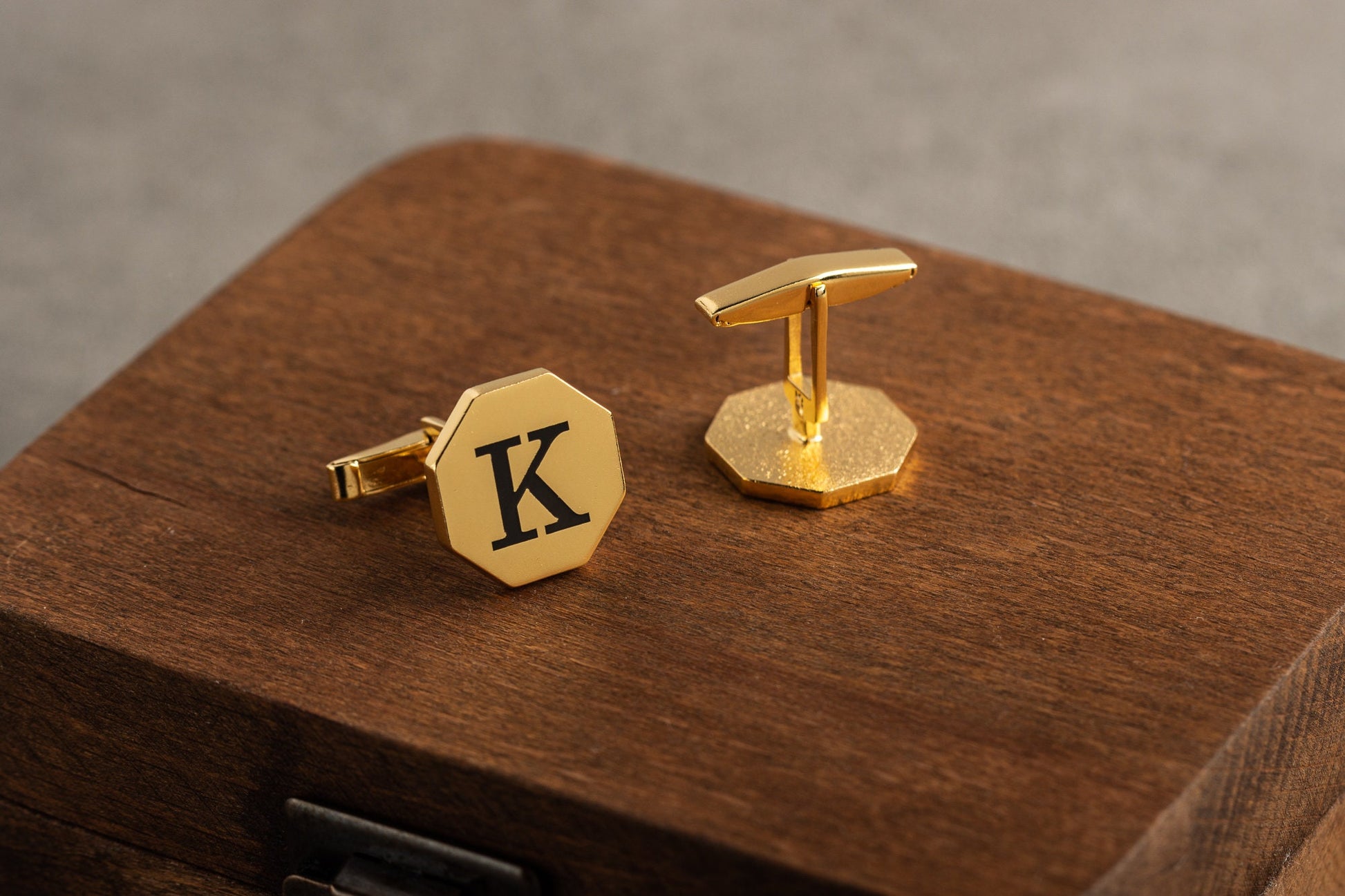 Close up of personalized hexagonal cufflinks in 18k gold finish
