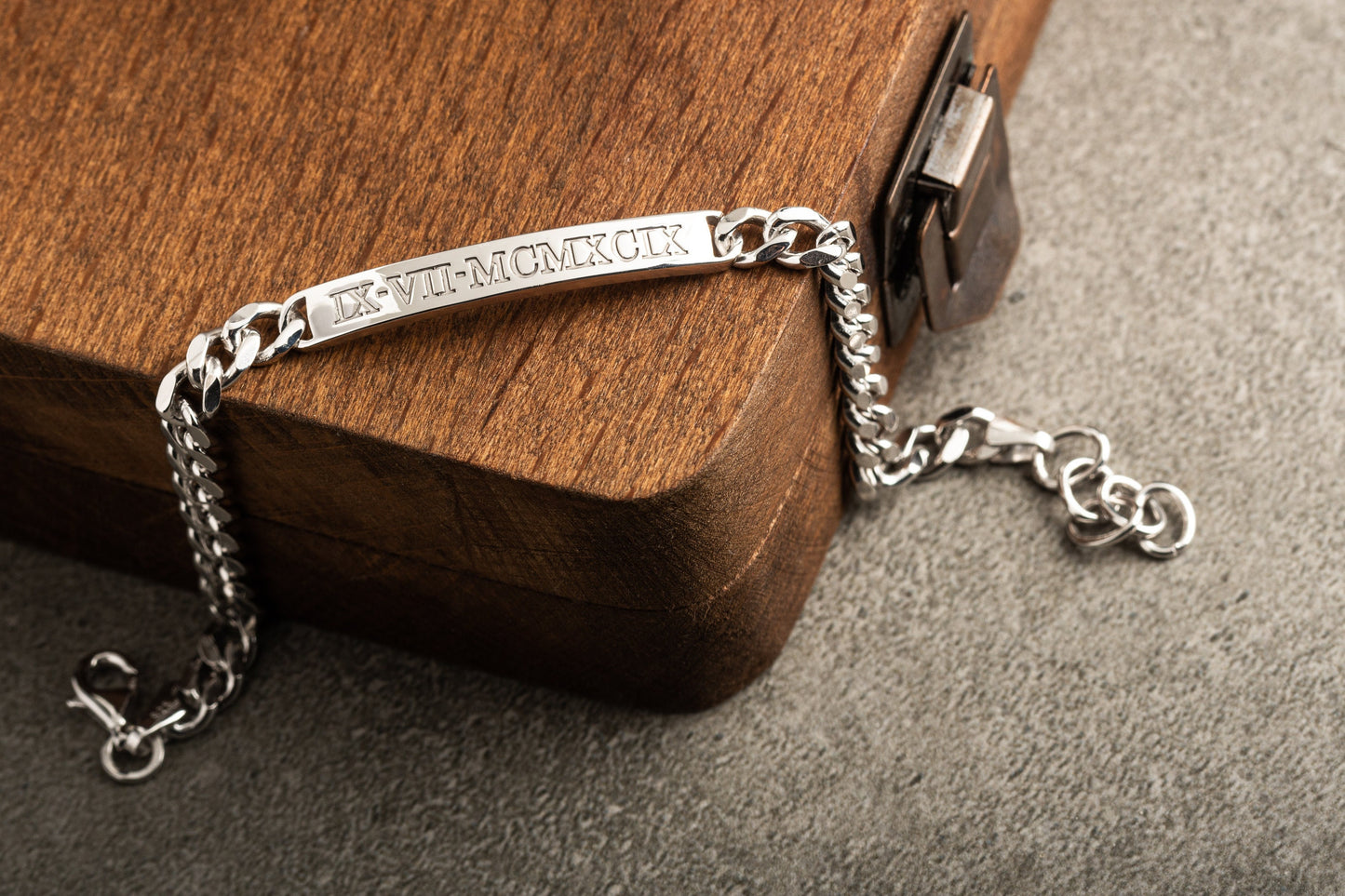 Close up of custom name engraved silver chain bracelet for men