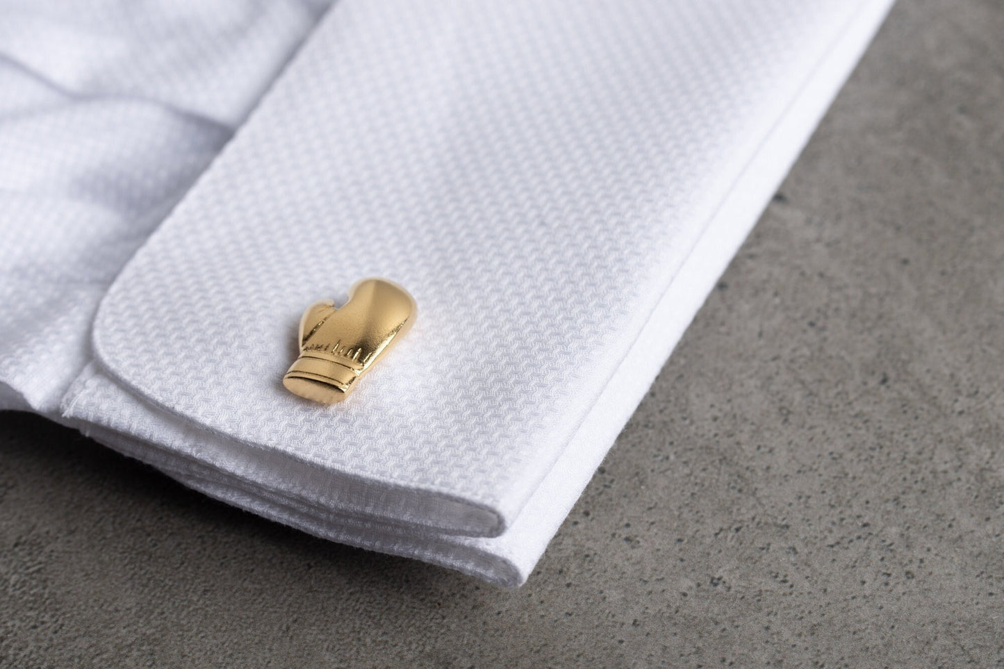 Close up of personalized boxing glove cufflinks in 18k gold finish