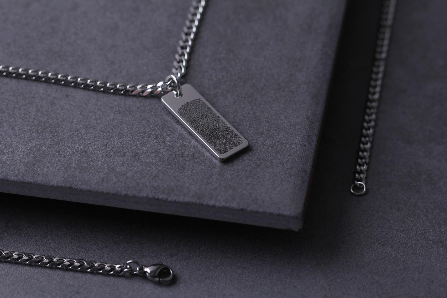 High-precision laser engraving detail of a baby fingerprint on a steel pendant