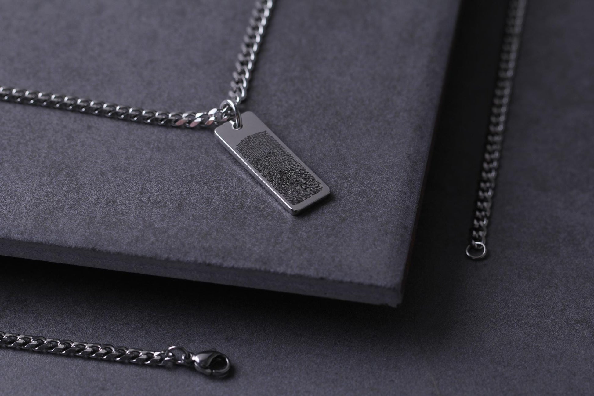 High-precision laser engraving detail of a baby fingerprint on a steel pendant