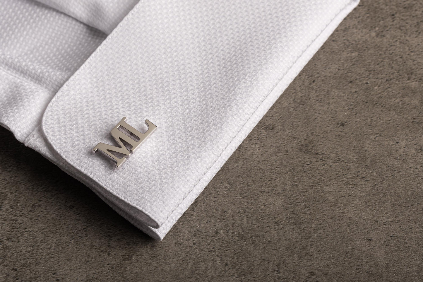 Close up of hand-cut 3D initial cufflinks for grooms - Magnolia Men