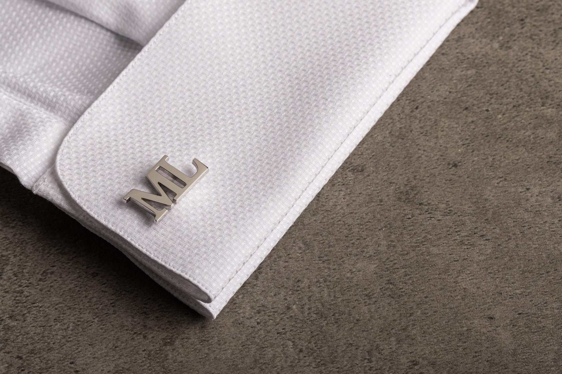 Close up of hand-cut 3D initial cufflinks for grooms - Magnolia Men